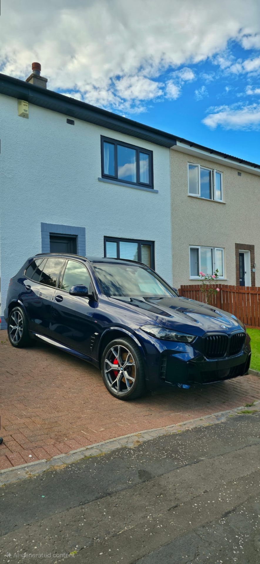 Dark blue BMW X5 on driveway after full valet