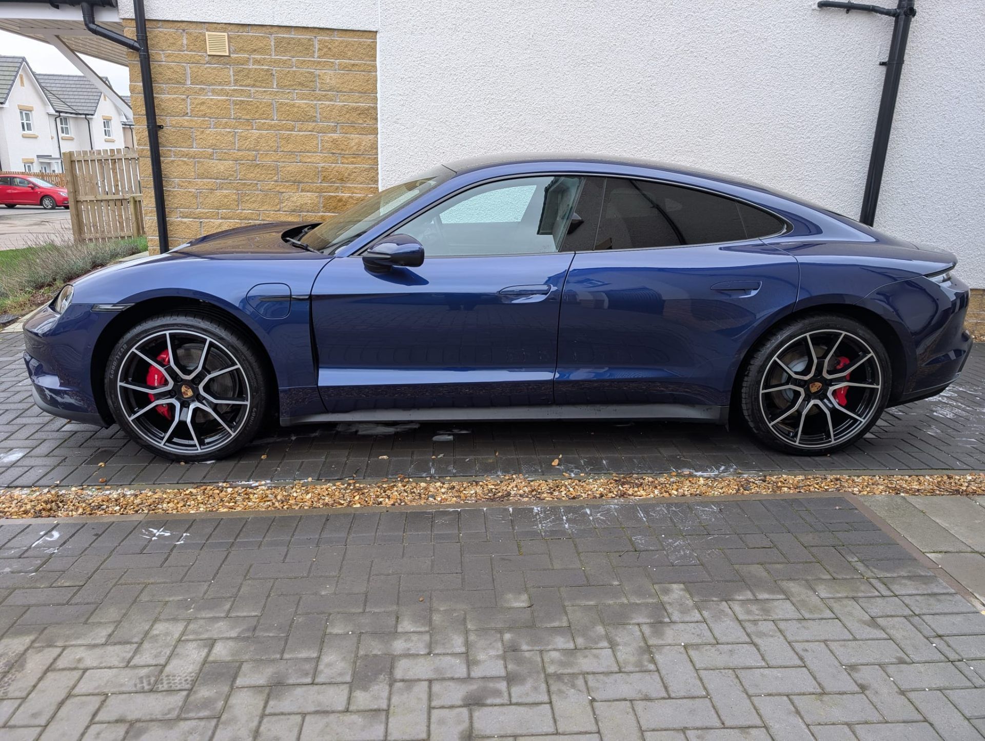 Blue Porsche Taycan side profile after full detail
